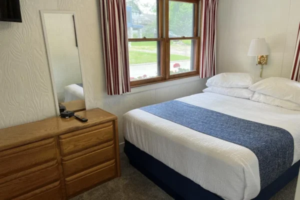 View of the street-side bedroom with a queen bed