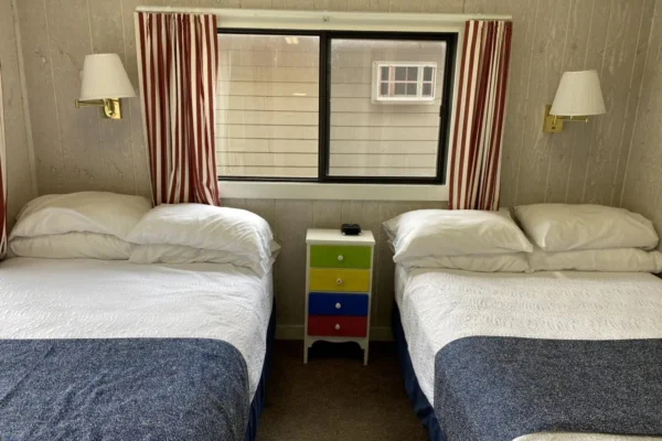 View of the street-side bedroom with two long-double beds