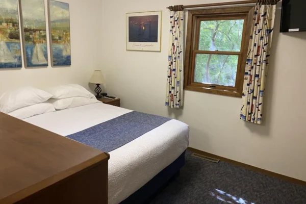 View of one of two upstairs bedroom with one queen bed