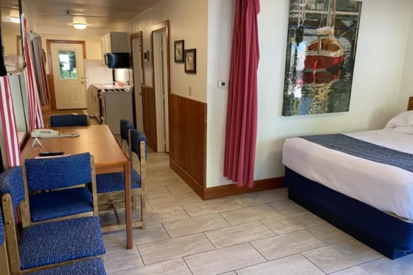 View of the living room with a queen bed and sofa sleeper